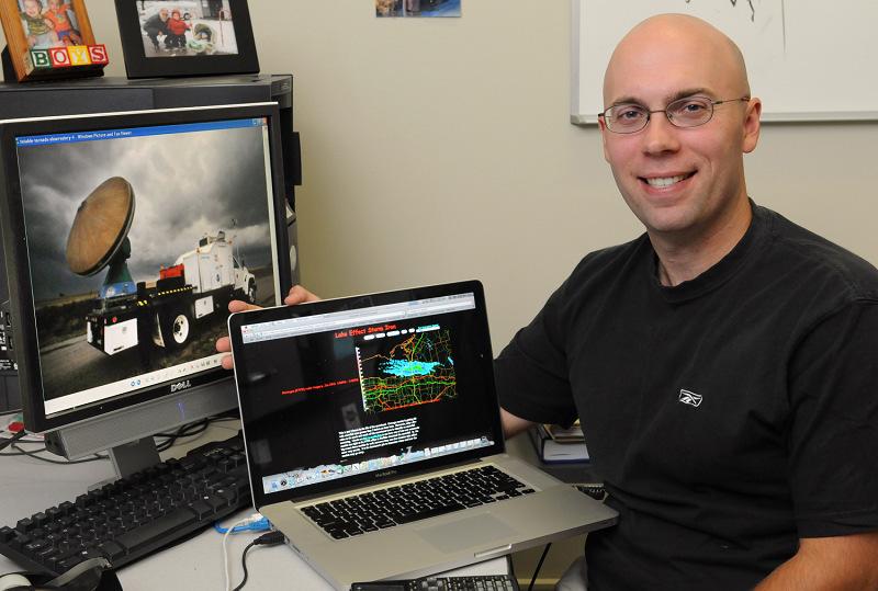 Meteorology Professor Scott Steiger ’99 shows images of the Doppler-on-Wheels truck and the data it will collect.