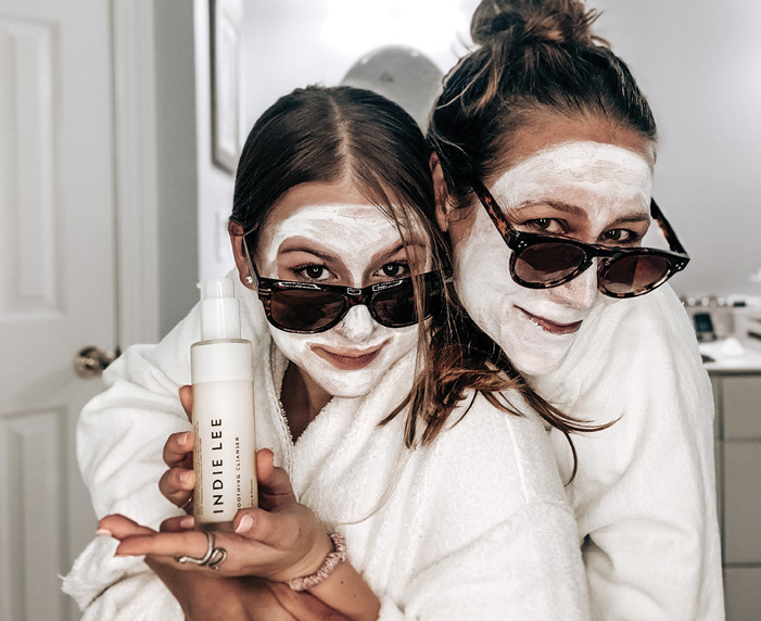 Indie Lee ’93 with her daughter, Emily, use an Indie Lee Clearing Mask, in 2021.