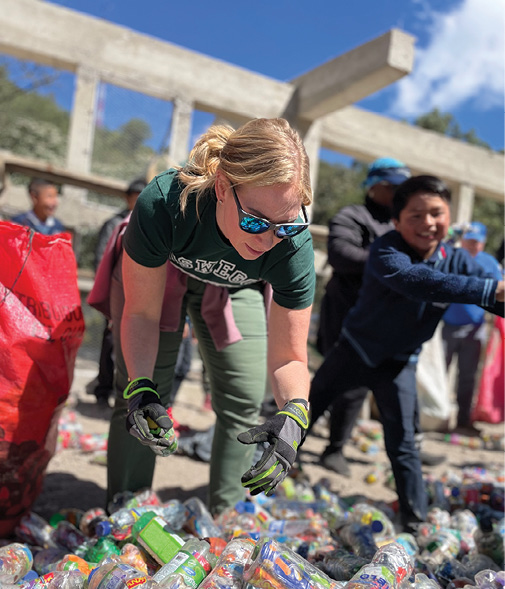 Nicole works alongside students to insulate two classrooms using plastic bottles and inorganic trash in a rural Guatemala in January 2023.