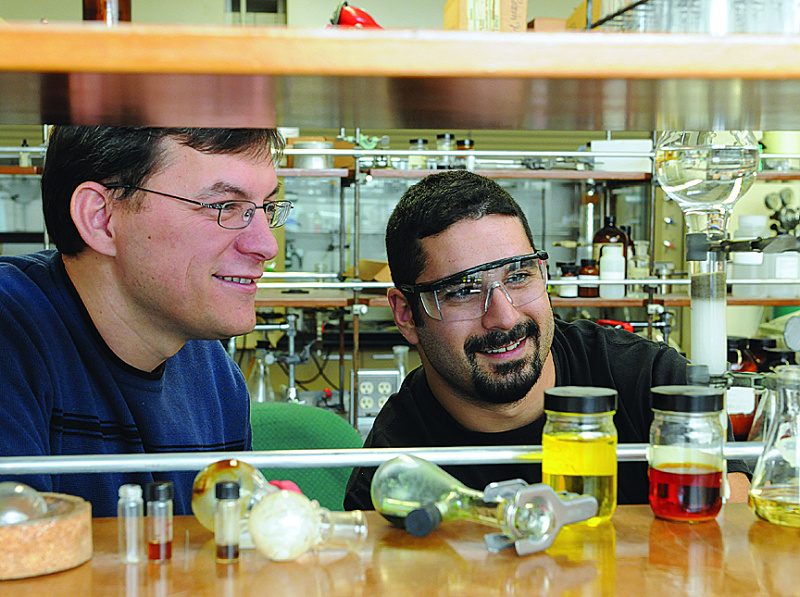 Professor Fehmi Damkaci, left, of the chemistry department works with Ned Karcich, graduate chemistry student in the Professional Science Master’s Program