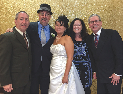 CHANG-HOLMES—Mark Holmes ’87 and Helen Chang were married at the South End Racquet Club in Torrance, Calif., on Nov. 5, 2016. From the left: Keith Chamberlain ’87, Mark Holmes ’87, Helen Chang, Wendy O’Dea ’87 and Bob Wolff ’87.