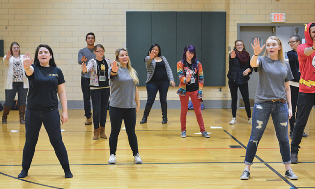 SERVICE IN ACTION—Members of Vocal Effect, SUNY Oswego’s show choir, offered a dance workshop last year in Swetman Gymnasium for Oswego Middle School students who are working with college students in Mentor Oswego, an academic and social support program aimed at helping schoolchildren reach their full potential.