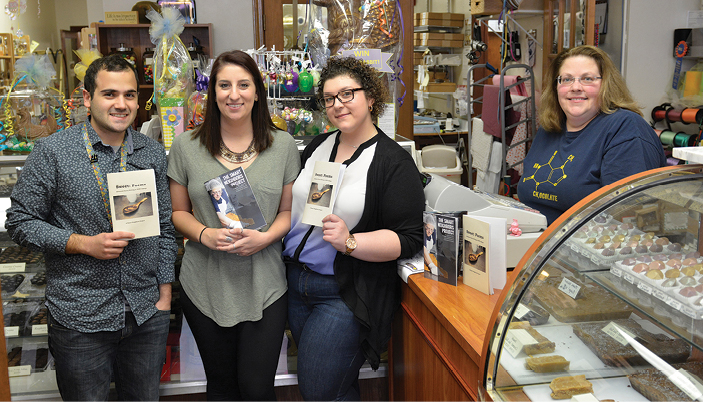 SUNY Oswego students (from left) Jesse Zavaro ’17, Marissa Specioso ’16 M’18 and Brittney Castagna ’18 are among dozens who are partnered with Man in the Moon Candies and its owner, Amy Stone-Lear (right), through the Smart Neighbors project.