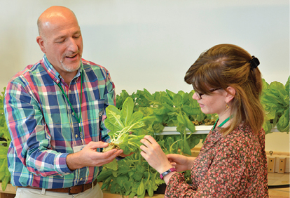 Baldwinsville Middle School Technology Education teacher Maurice “Mo” Lepine ’84 M’89 (above left) discussed growing lettuce hydroponically with technology education senior Erika Wallace ’18, who is the daughter of another Baldwinsville Technology Education teacher Annette Whitmer Wallace ’90 M’98, during the annual Technology Conference at SUNY Oswego in October.
