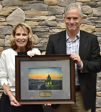 President Deborah F. Stanley and David DeVillers '89 holding Distinguished Alumnus Award