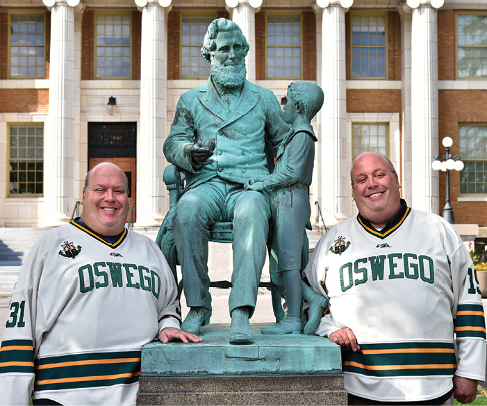 Pictured: Tom Little '92 and Don Little '91 in front of Sheldon Hall standing next to statue of Sheldon