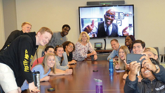Students sitting around a table with Professor Michael Riecke, Vanessa Richards '08, and Al Roker '76