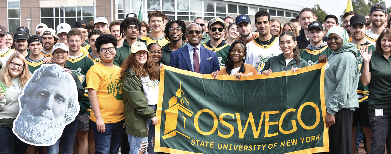 President Nwosu with SUNY Oswego students, facutly and alumni during the green and gold day campus photo